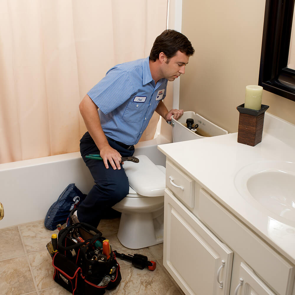 Sewer line cleaner inspecting a Milwaukee homeowner's toilet