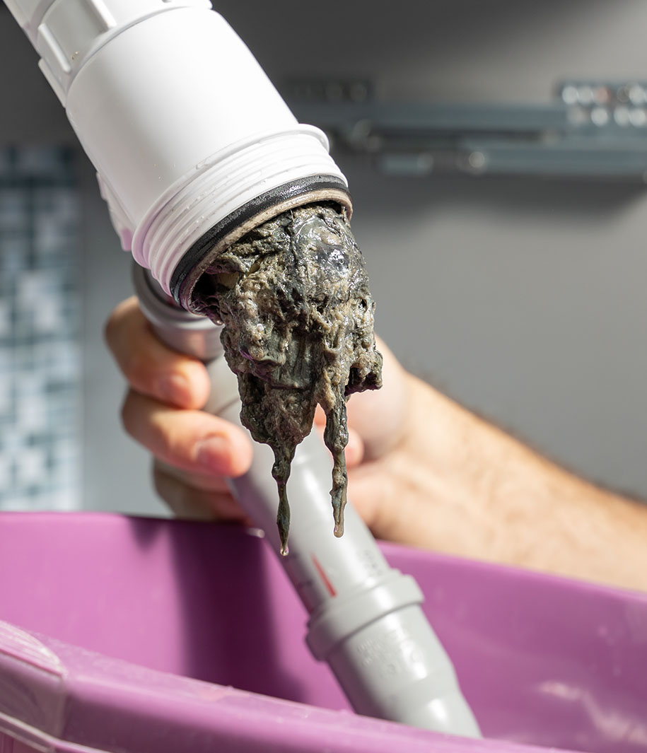 kitchen drain being unclogged
